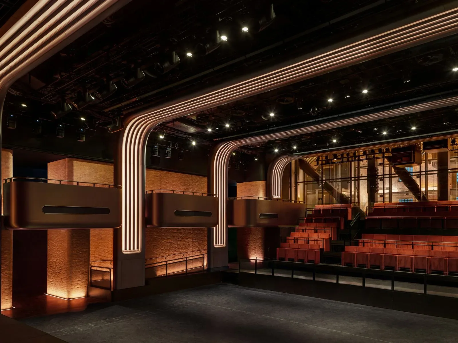 Heritage brickwork and bronze balconies inside Apple Music Hall