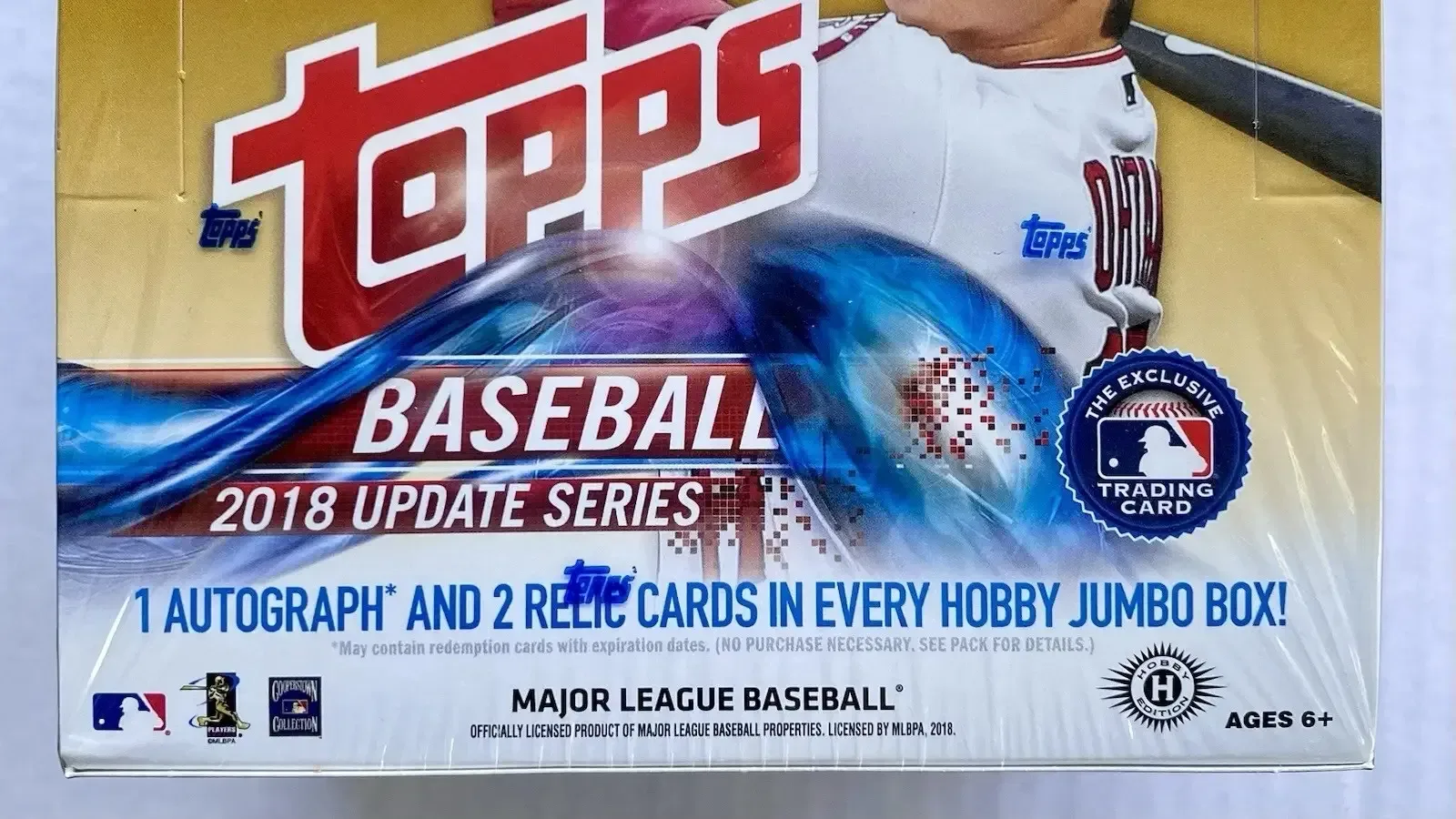 Vintage and modern sealed trading card boxes displayed together