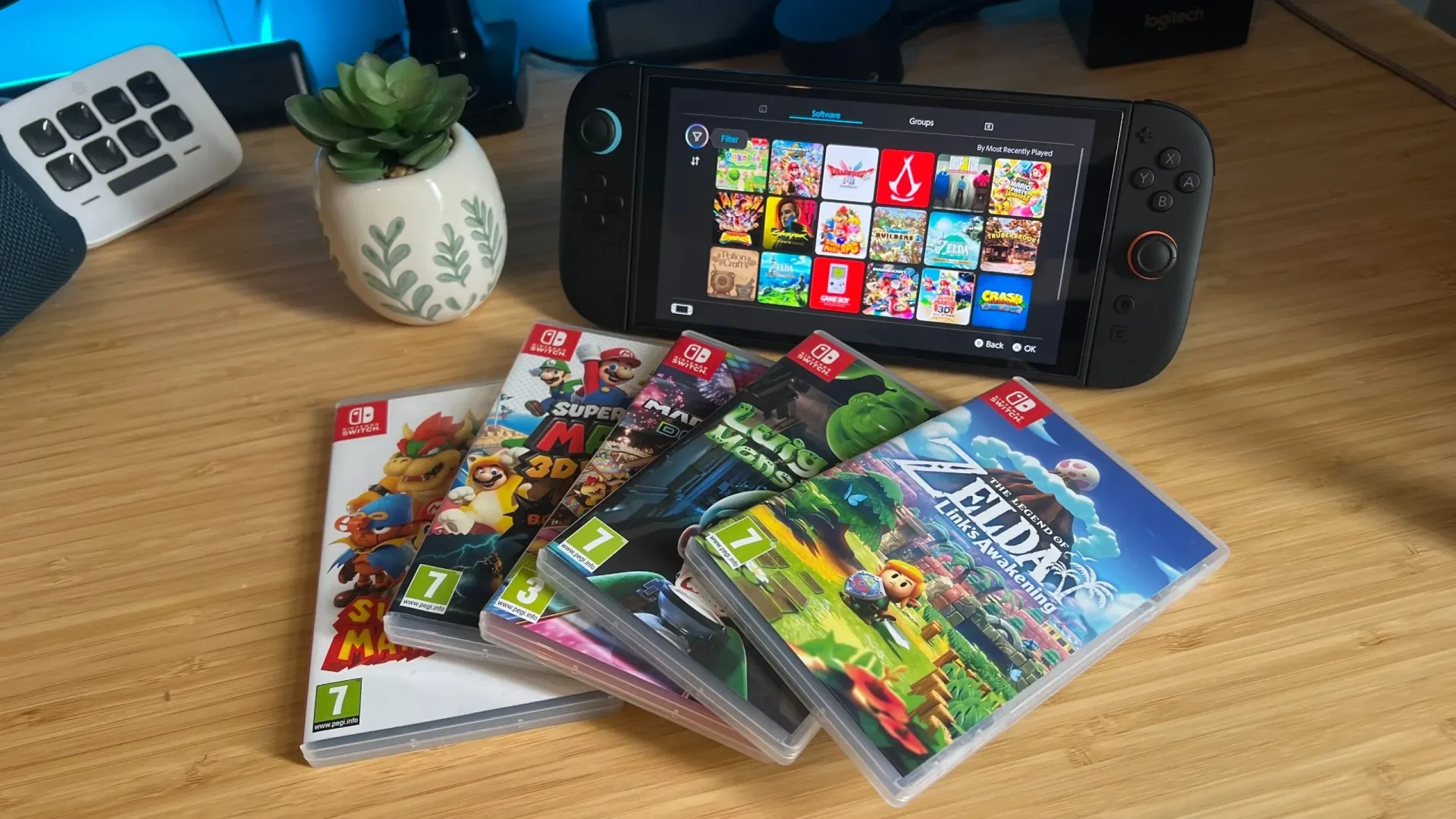 Nintendo Switch games with Switch 2 handheld on a wooden desk