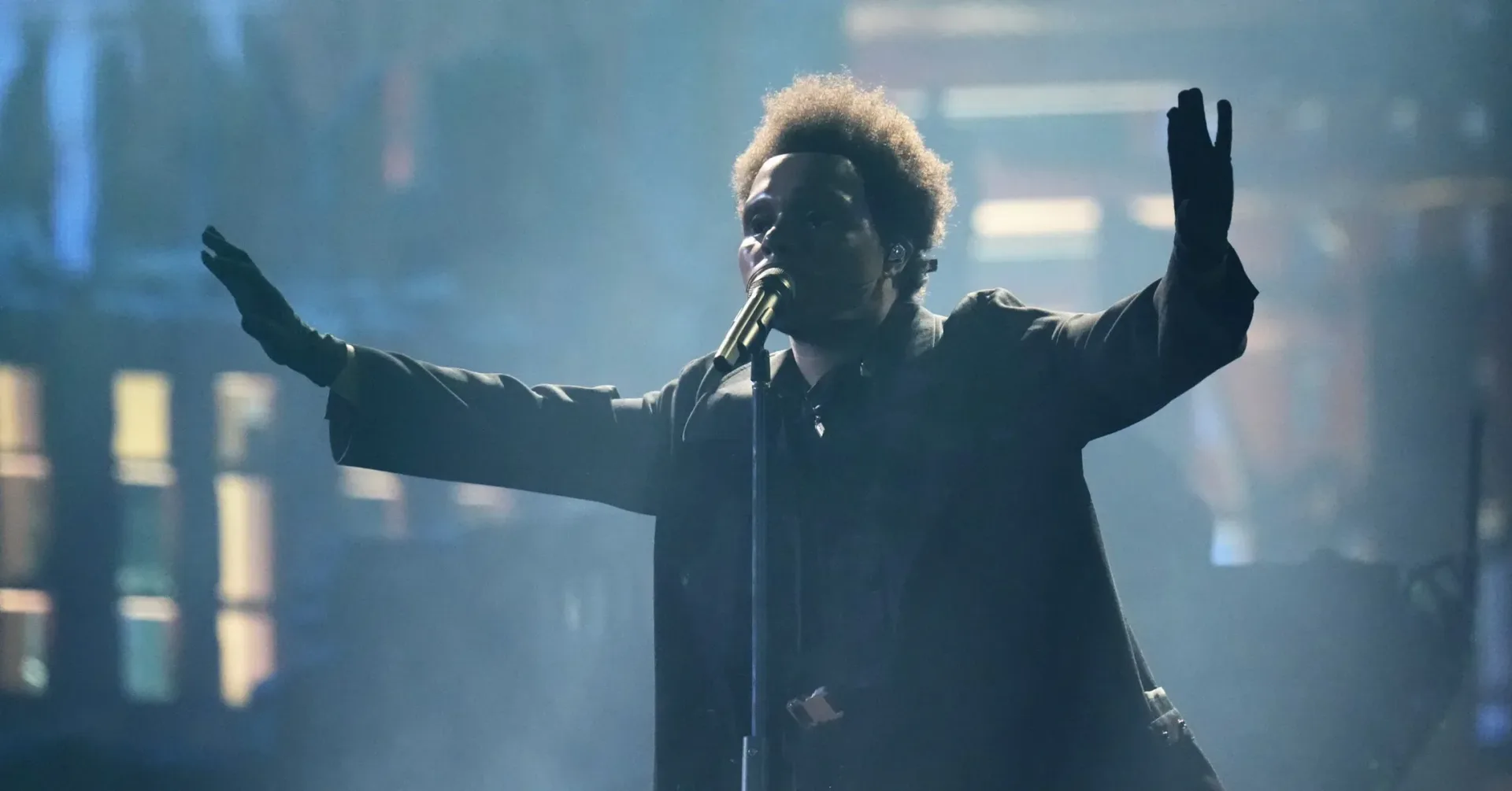 The Weeknd performing onstage during a concert