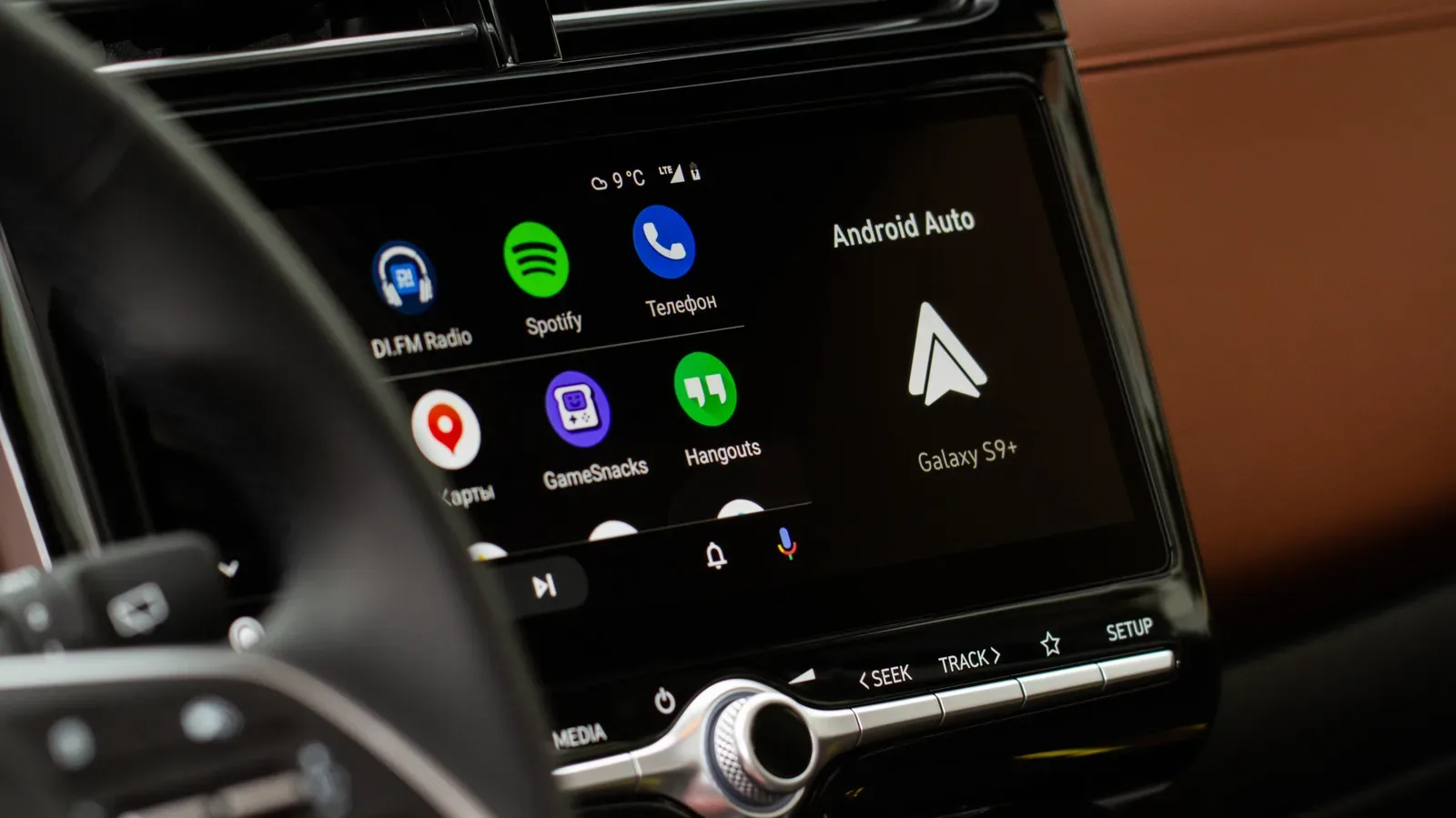 Android Auto dashboard display with navigation prompt lowering music volume