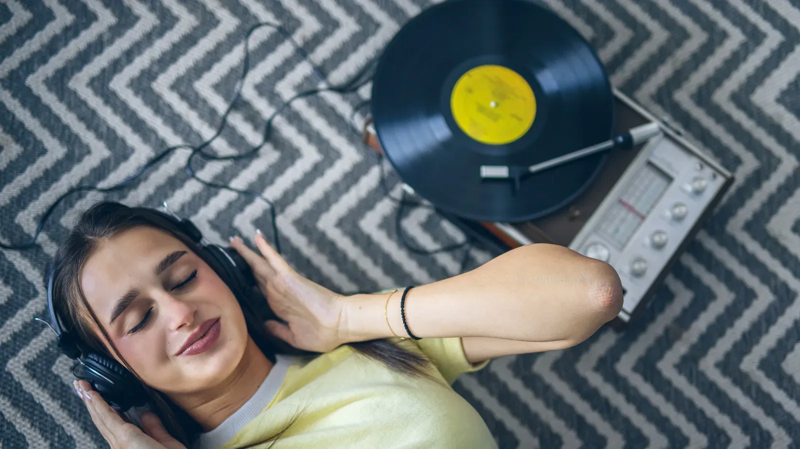 Close-up of a turntable stylus resting in a vinyl record groove
