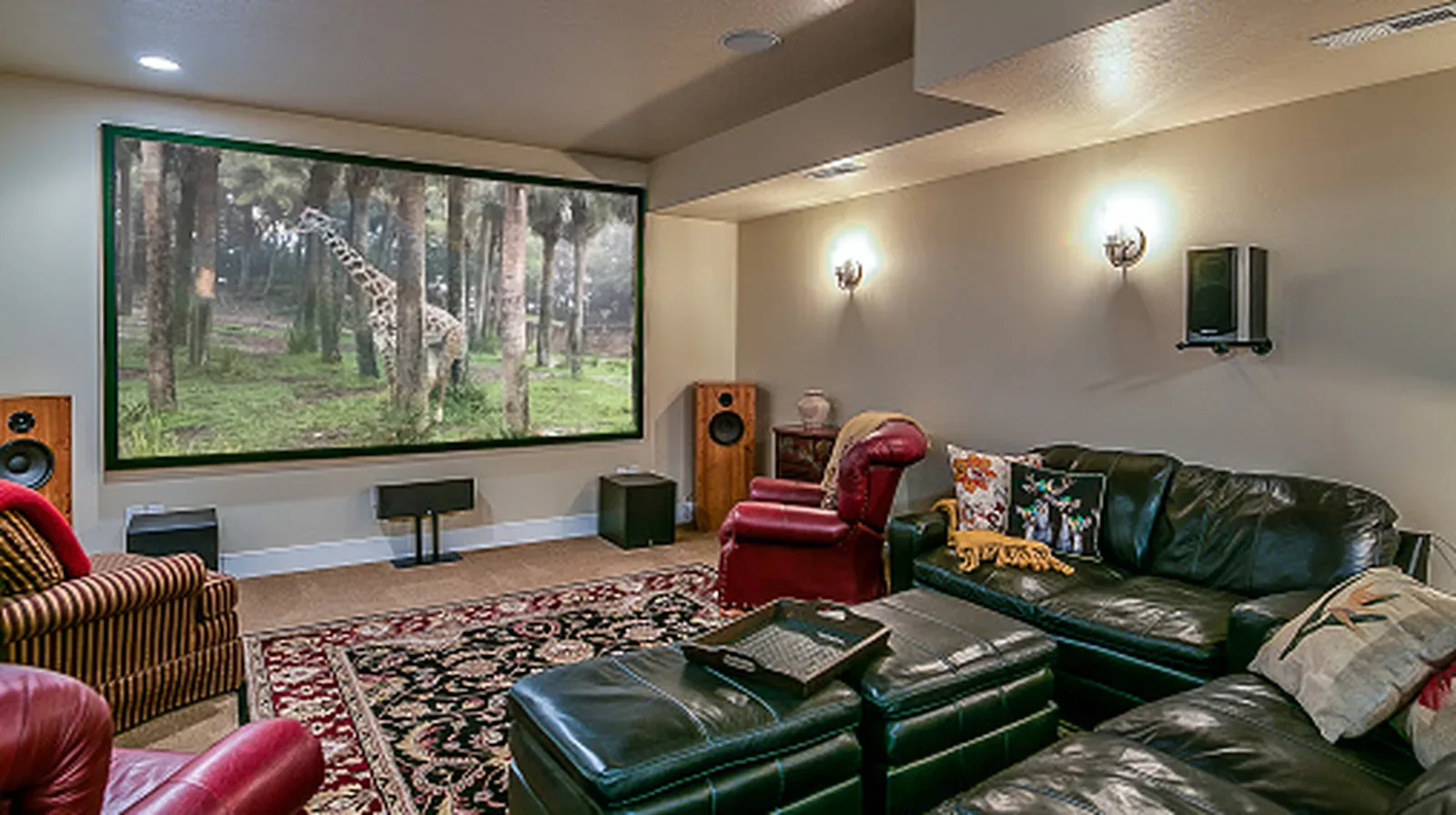 Front left, center and right speakers aligned near a seated listener’s ear height