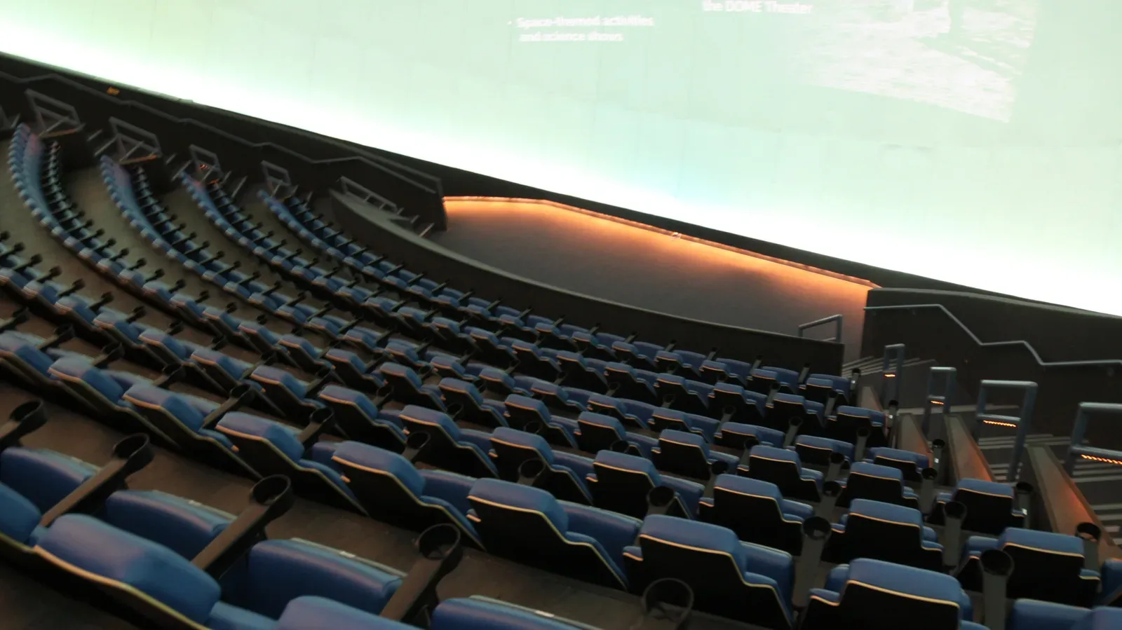 A towering IMAX cinema screen viewed from inside an auditorium