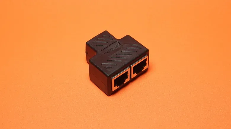 A powered Ethernet splitter with a power input and multiple network ports