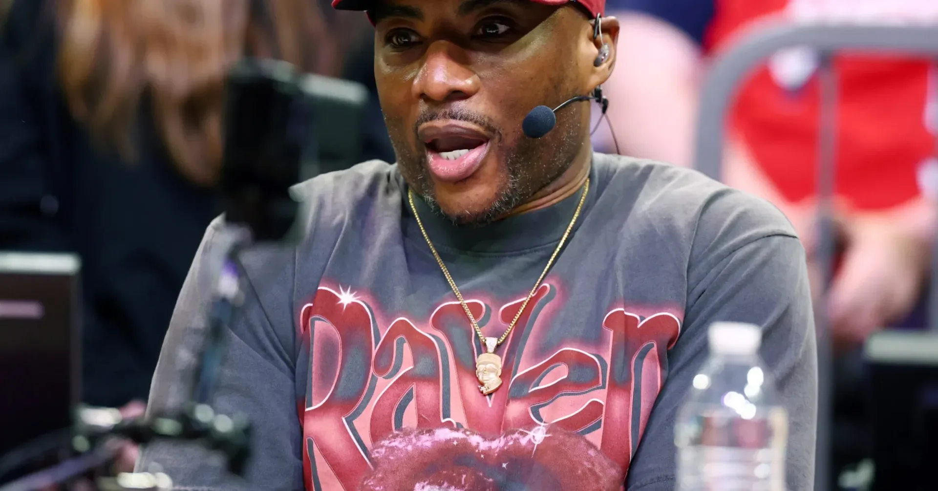 Charlamagne Tha God speaking into a studio microphone