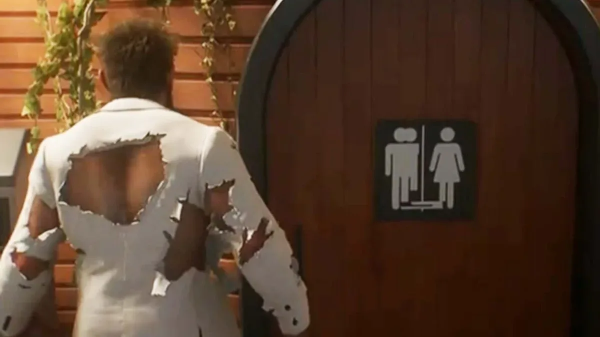 A garbled restroom sign in Marvel’s Wolverine affected by a UV map bug
