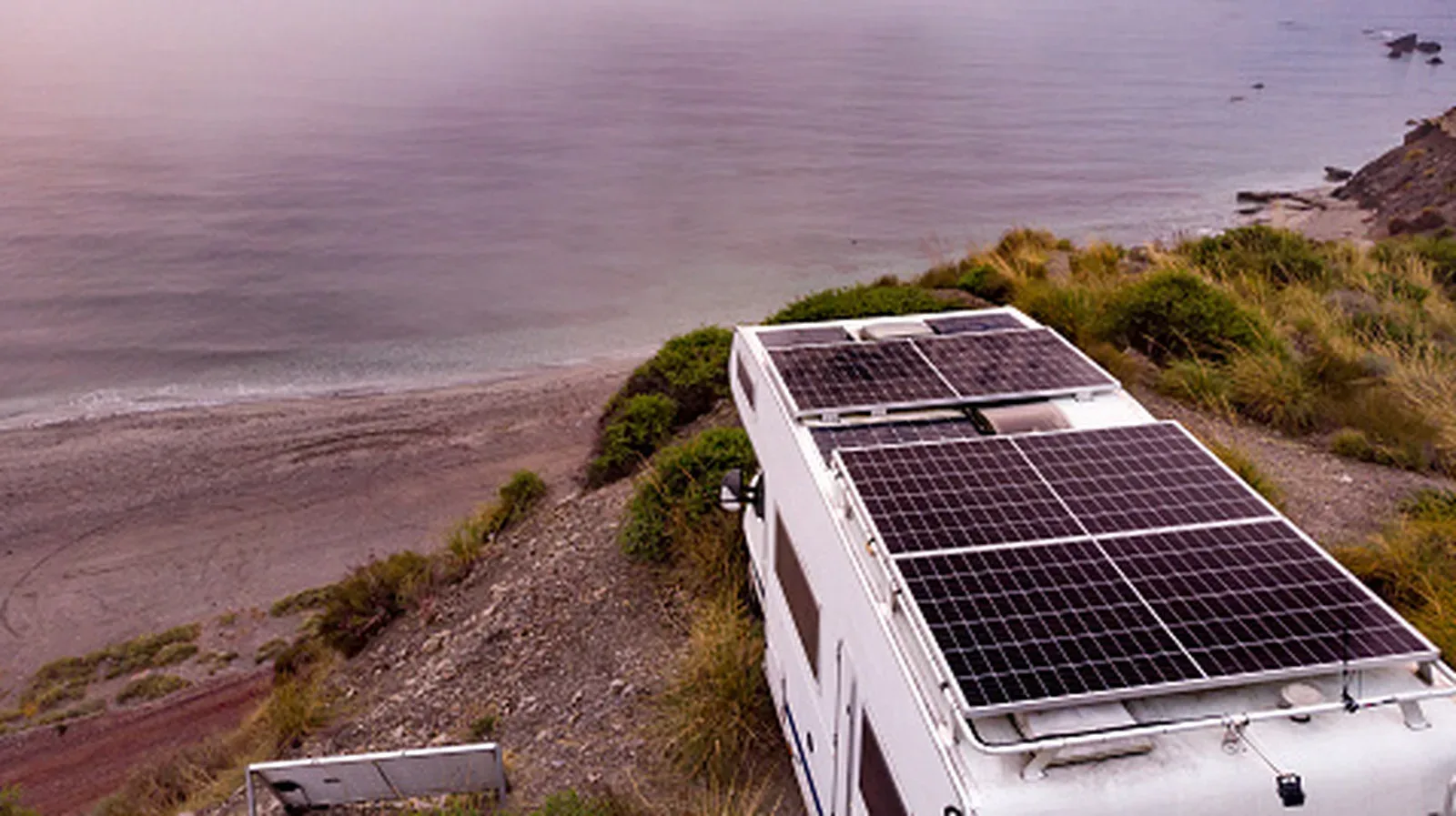 Roof-mounted solar panels on an RV parked in bright daylight