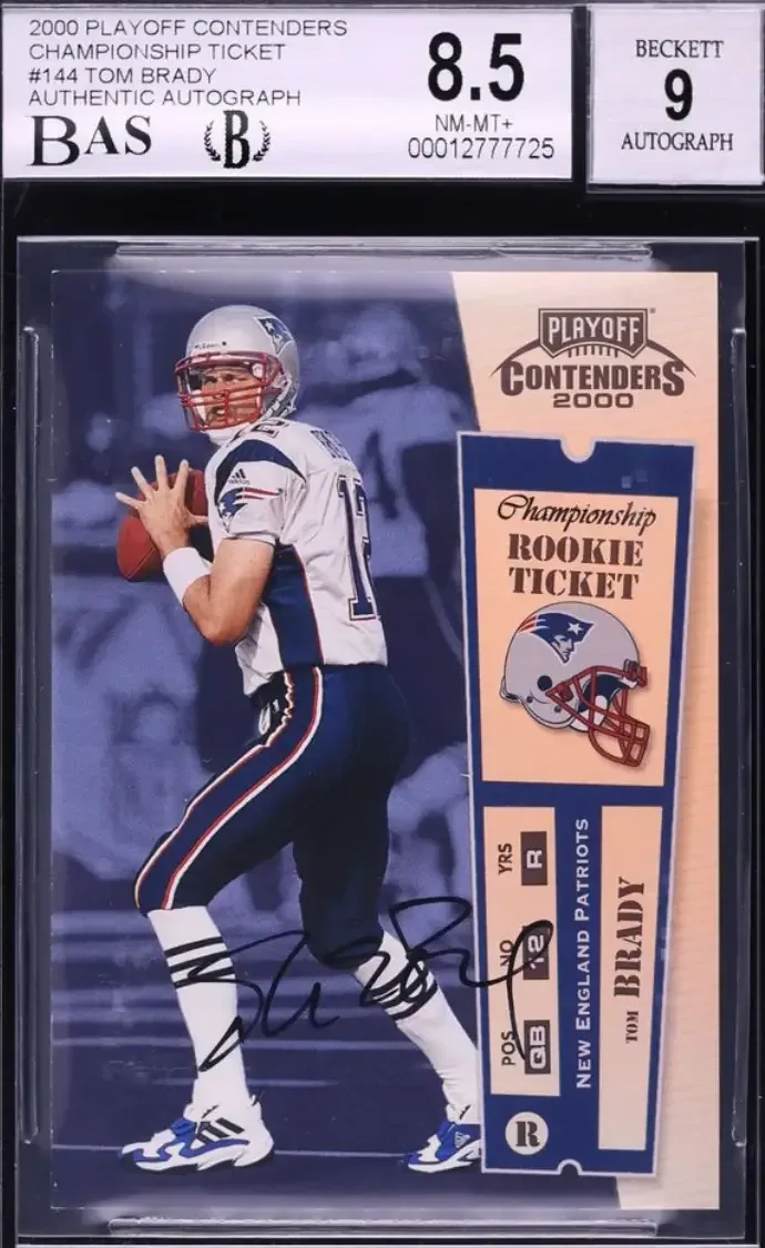 Image of Brady in white Patriots uniform, silver helmet, dark blue pants, holding football in right hand.