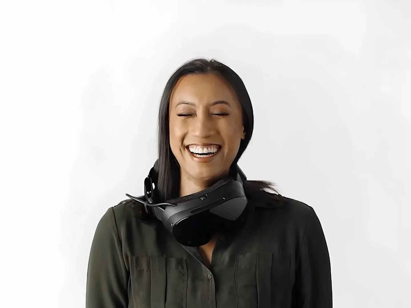 A woman laughingly wearing the Steam Frame "wrong" in one of Valve's user guide videos for the headset
