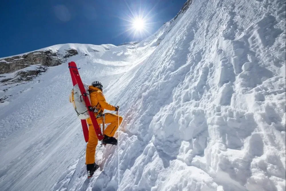 Jim Morrison skis beneath the towering snow-covered slopes of Mount Everest