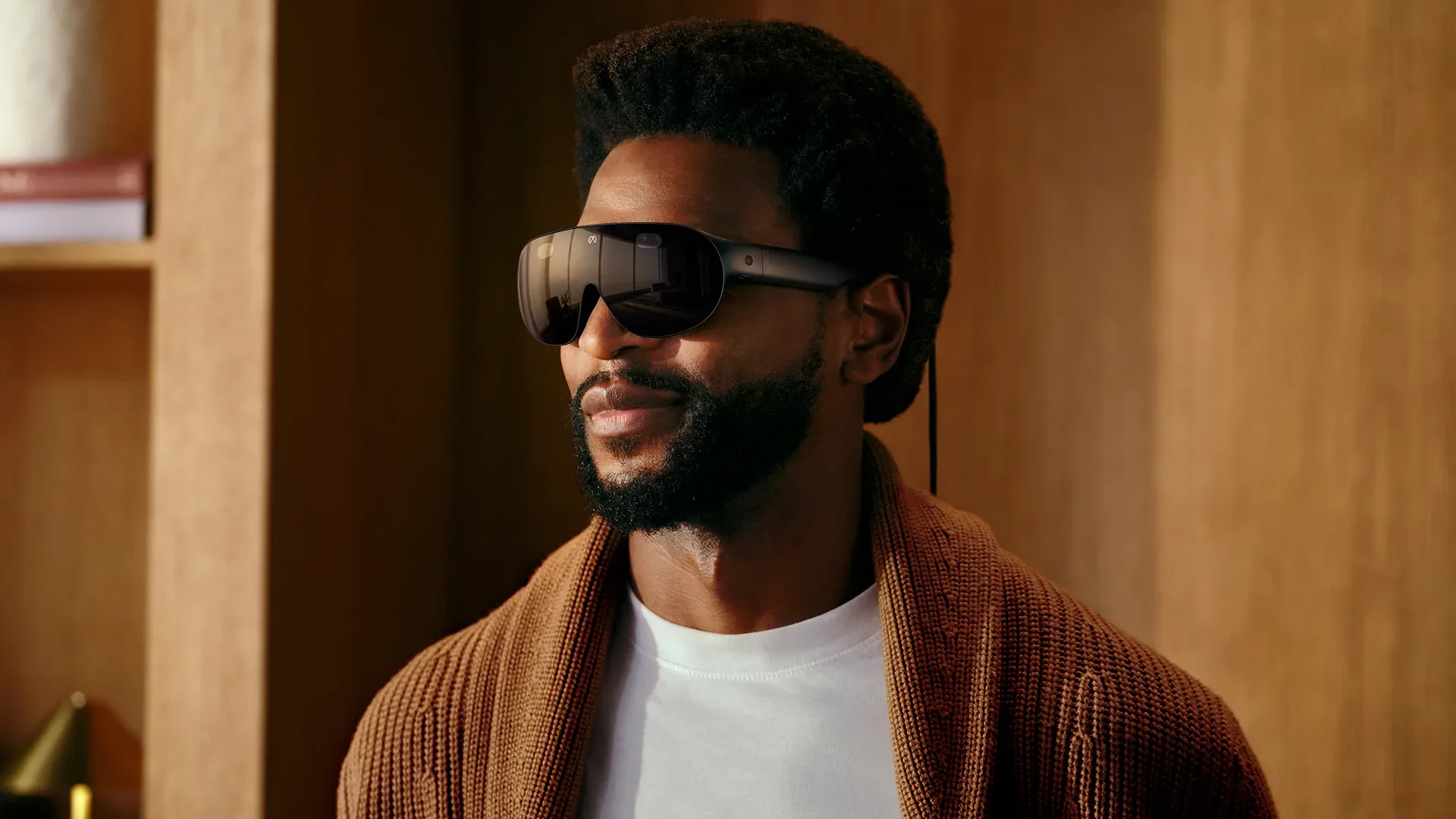 Meta VR glasses connected by a wire to an external compute and battery puck