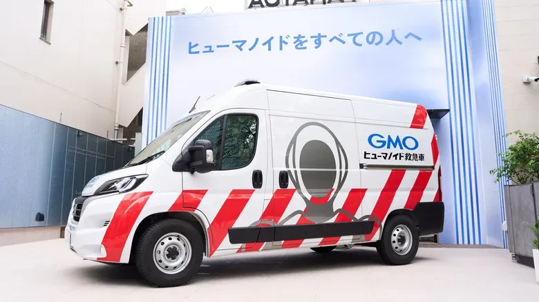 A mobile robot repair vehicle carrying tools, diagnostic equipment and a replacement humanoid
