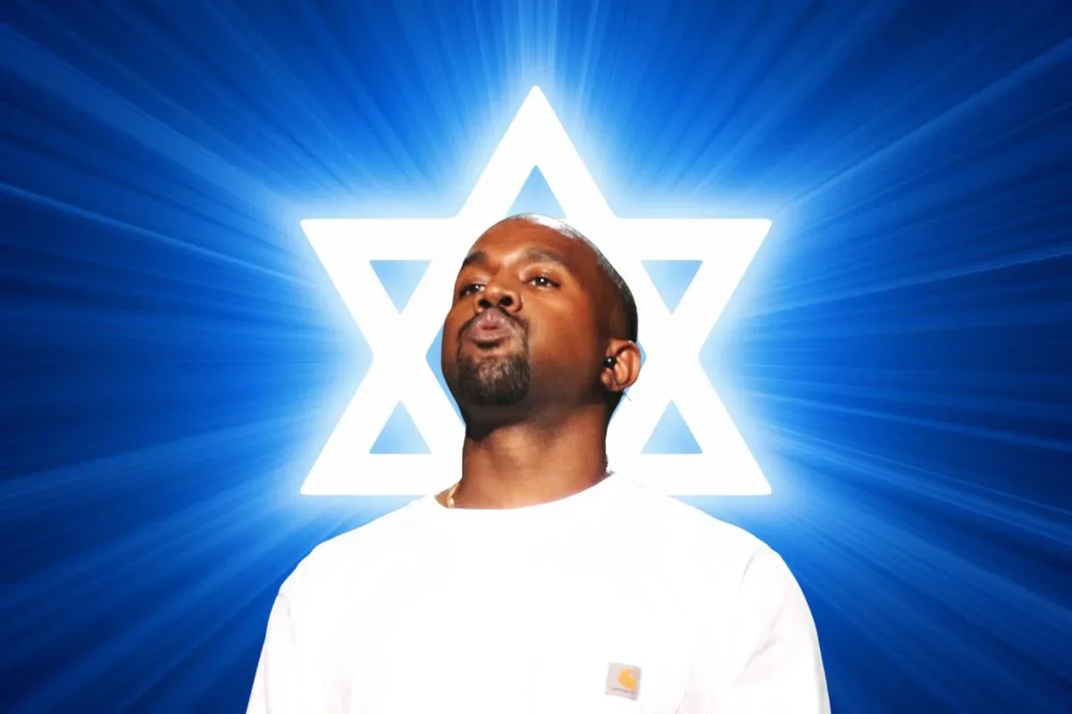 Ye performing onstage during a live music event