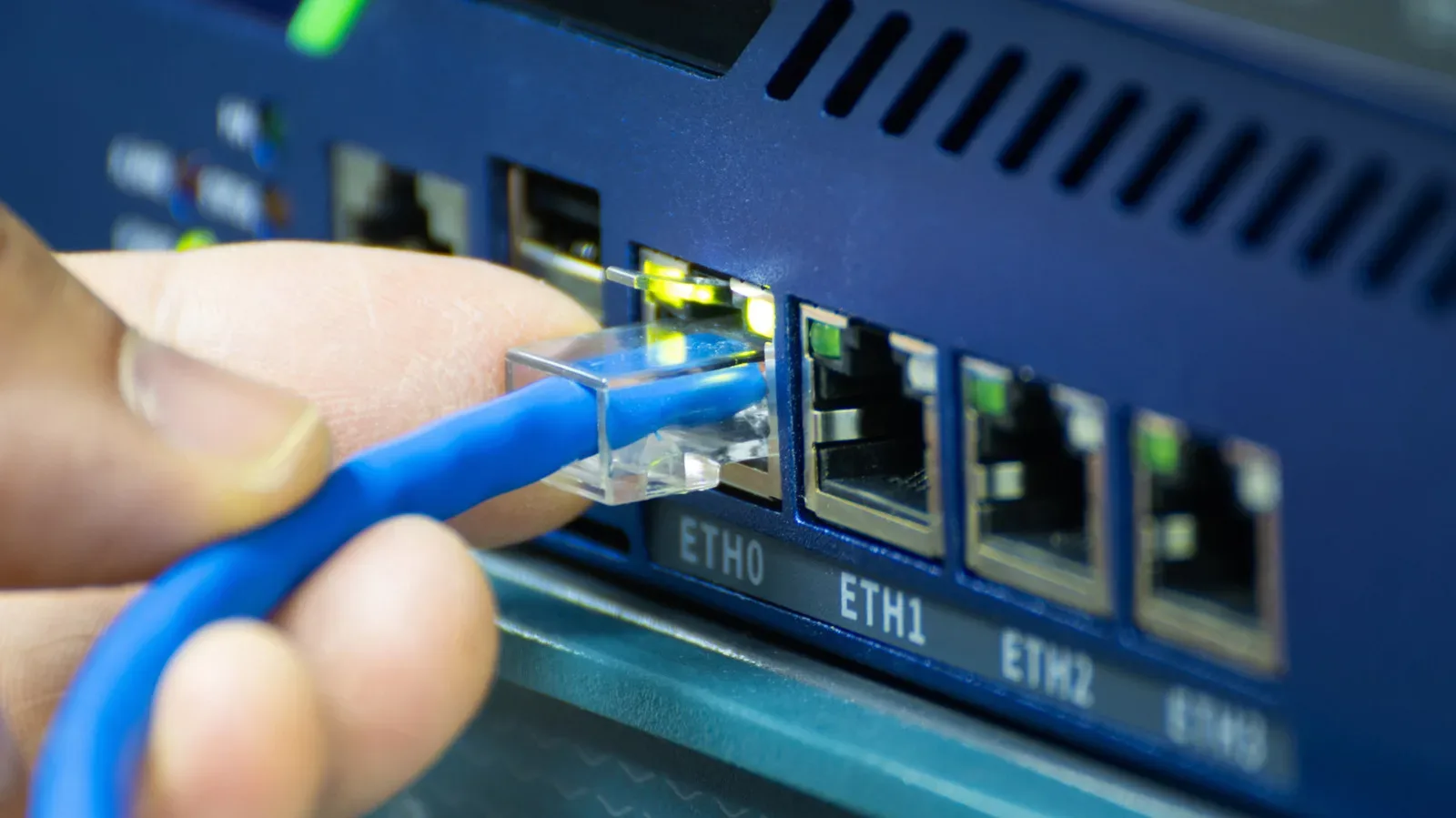 An unmanaged Ethernet switch connected to a gaming PC, console, TV, and router cable