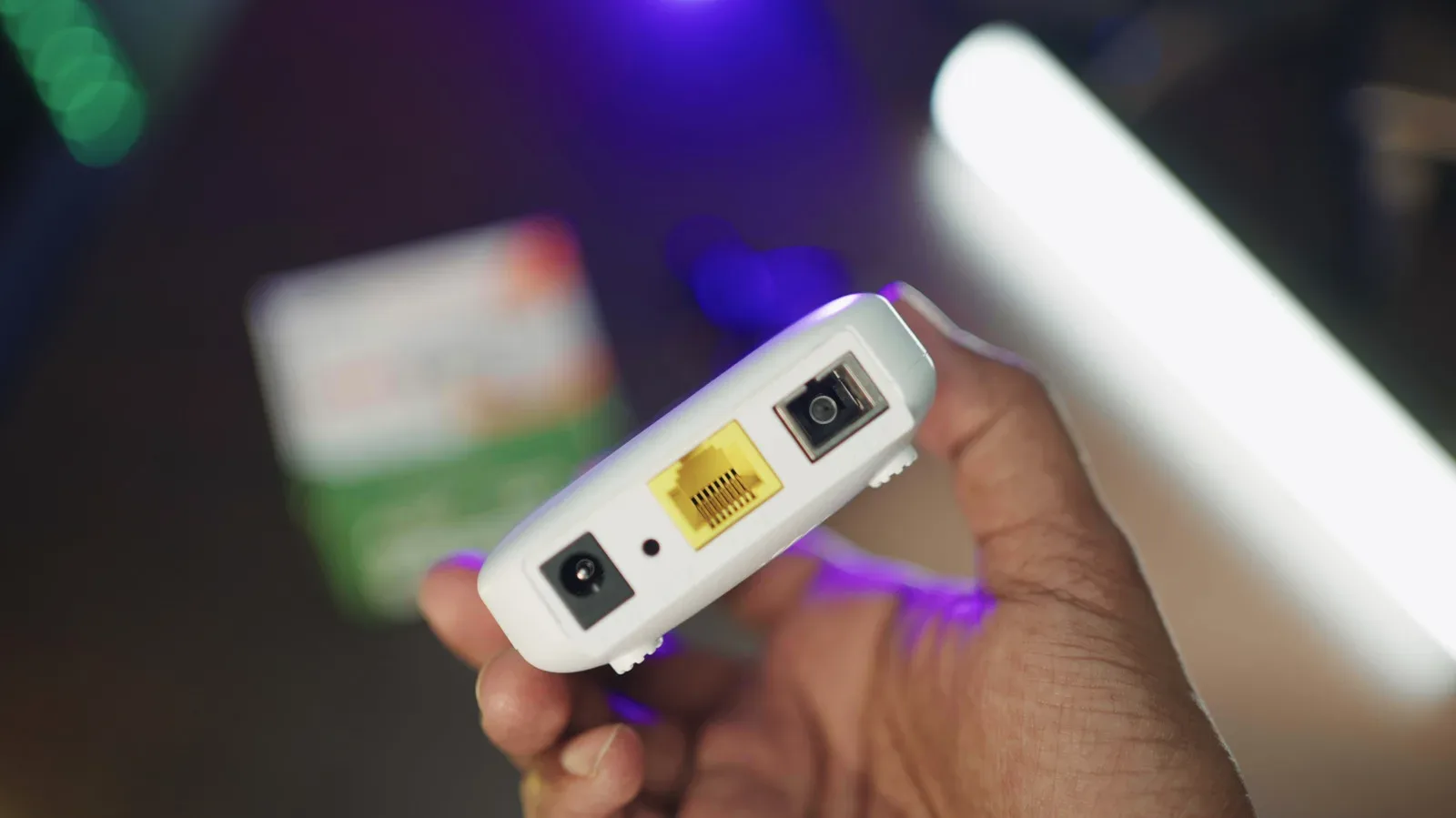 Compact travel router connected to a hotel Wi-Fi network for several gaming devices