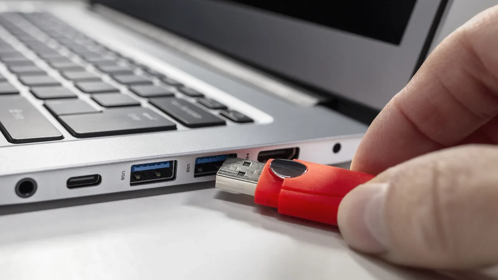 An external SSD connected to a laptop, illustrating safe drive ejection