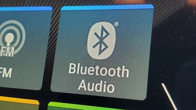 A car infotainment display showing paired phone devices
