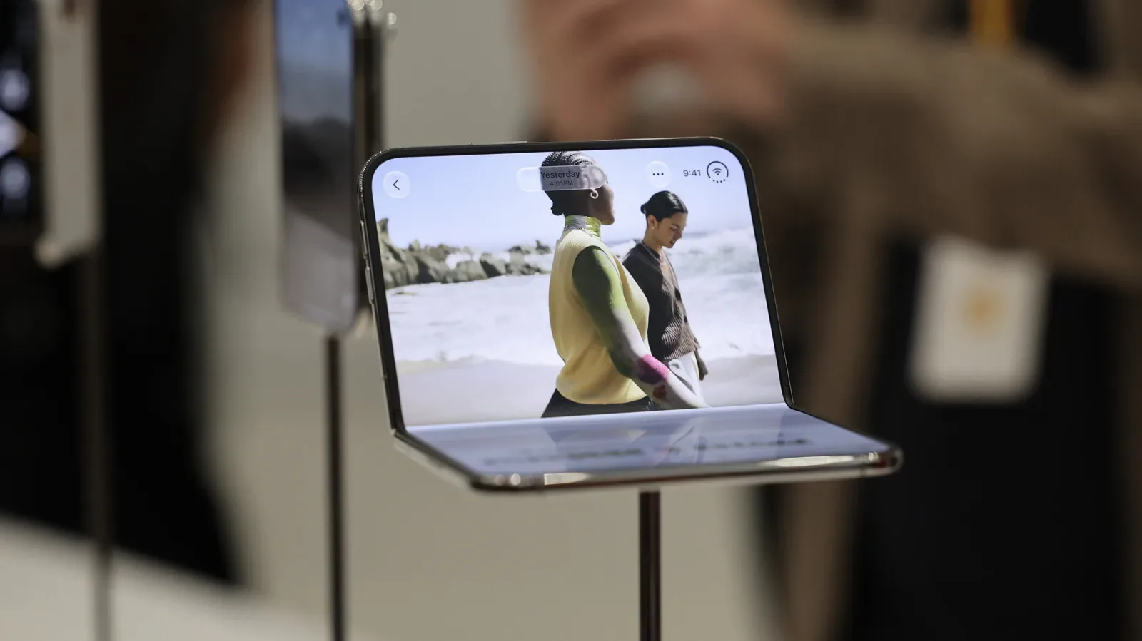 Apple iPhone Duo shown folded and opened beside a split-screen multitasking view