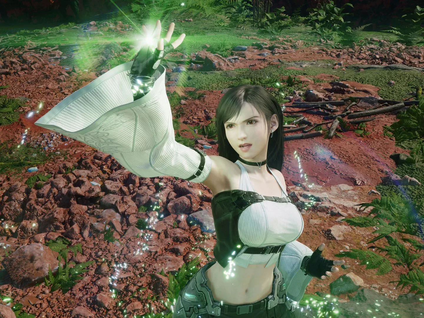 Tifa where's a mage-like outfit as her hand glows green in Final Fantasy 7 Revelation