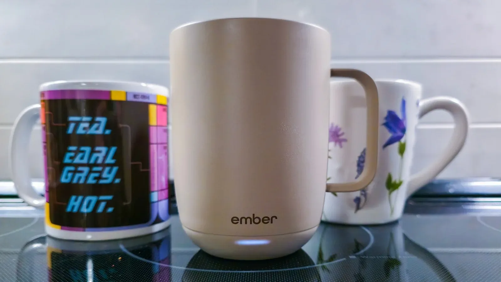 Ember Mug 3 self-heating mug resting on its charging coaster