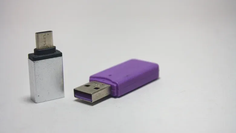 Close-up of USB-A and USB-C connectors beside gaming accessories