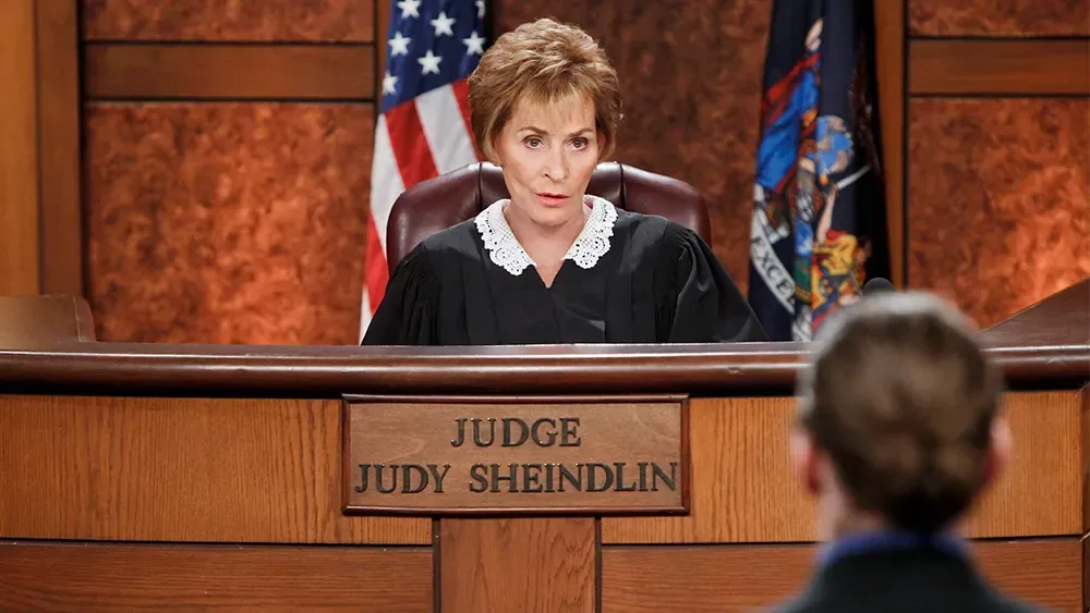 Judith Sheindlin in her signature judicial robe during a television appearance