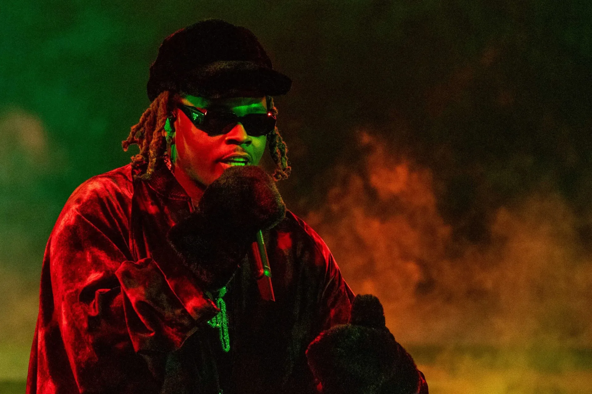 Gunna performing onstage during a live hip-hop set