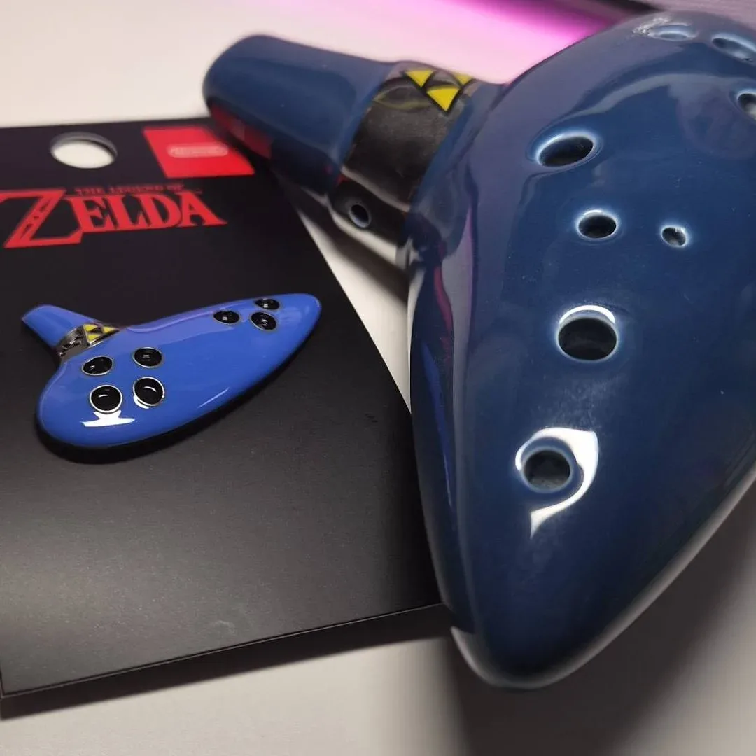 Close view of the Ocarina pin’s recessed instrument holes and Triforce detail