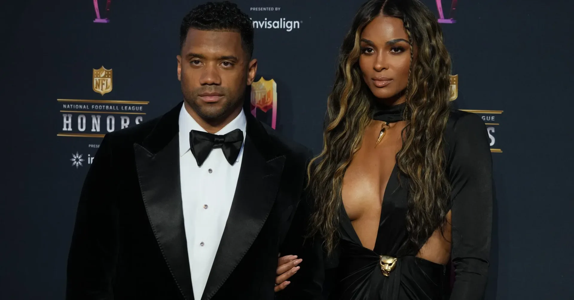 Ciara and Russell Wilson pregnancy announcement video with white shirts on a clothesline and a blank baby onesie