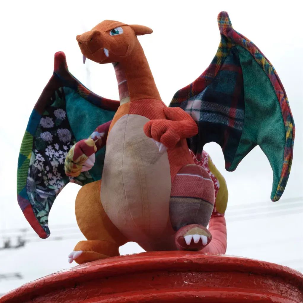 Vintage-inspired Bulbasaur and Charizard plush with mixed textile patterns