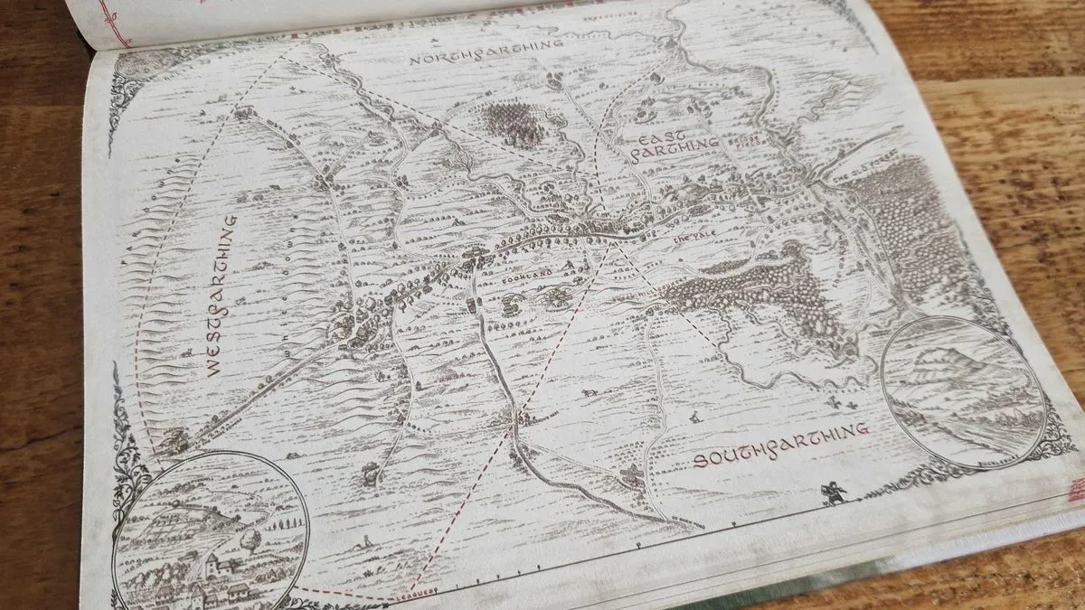 The One Ring Hobbit Tales map of the Shire, laid out on a wooden surface
