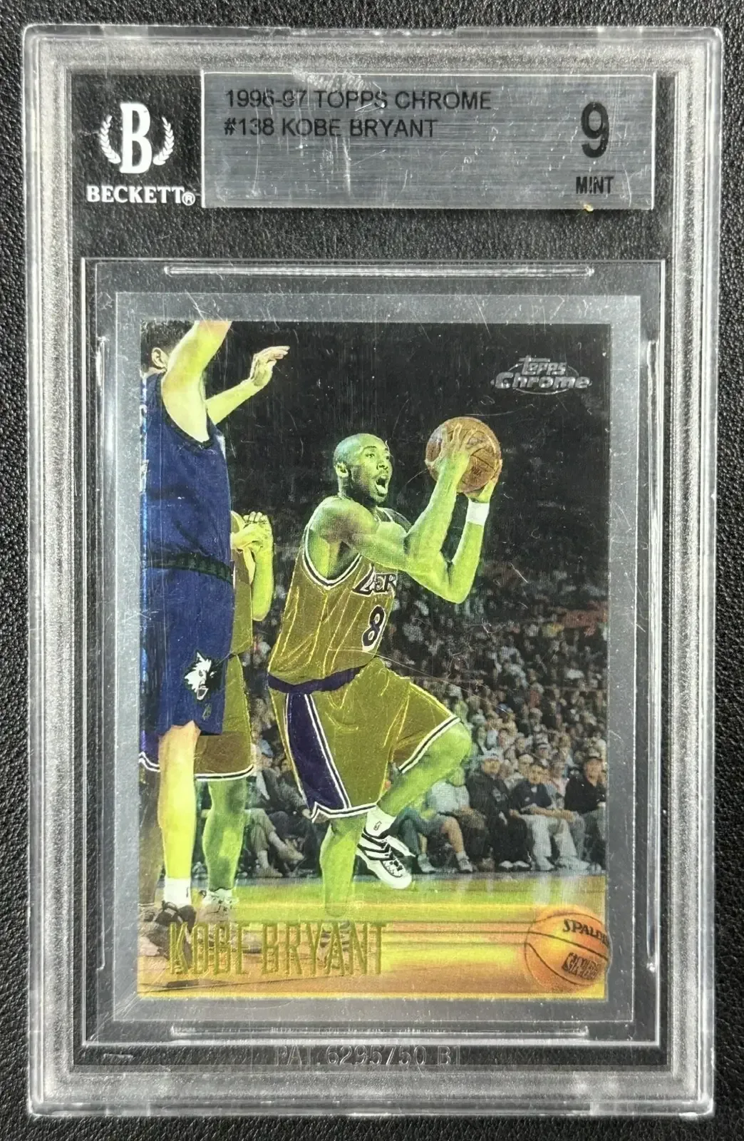 Sports card display cabinet with cards held upright in shelf grooves