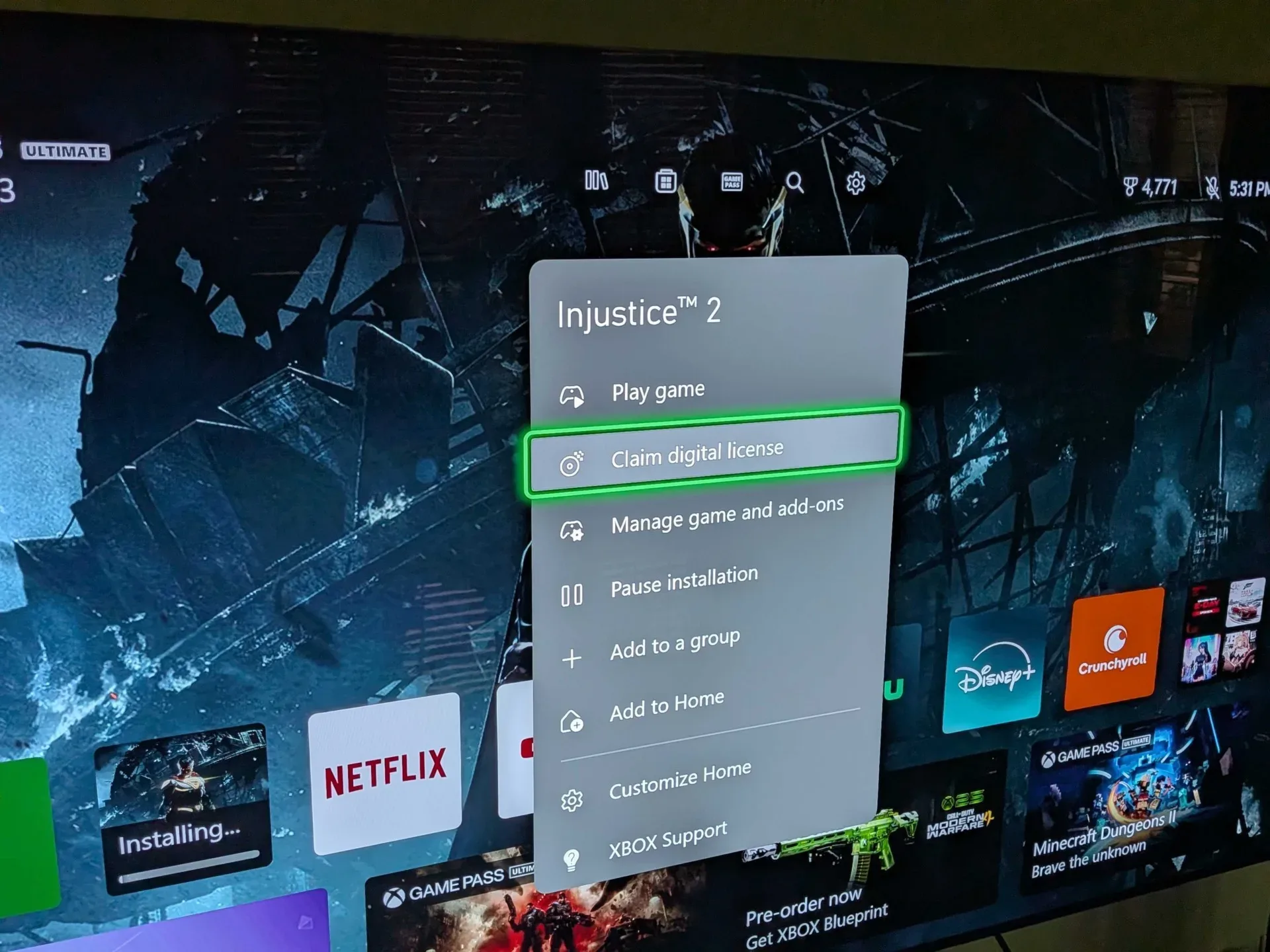An Xbox Series X console with a physical game disc ready to claim a digital license
