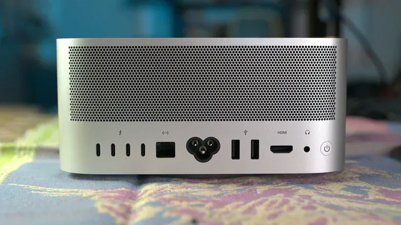 The back of the new Mac Studio M5 Ultra computer with a blue and pink background.