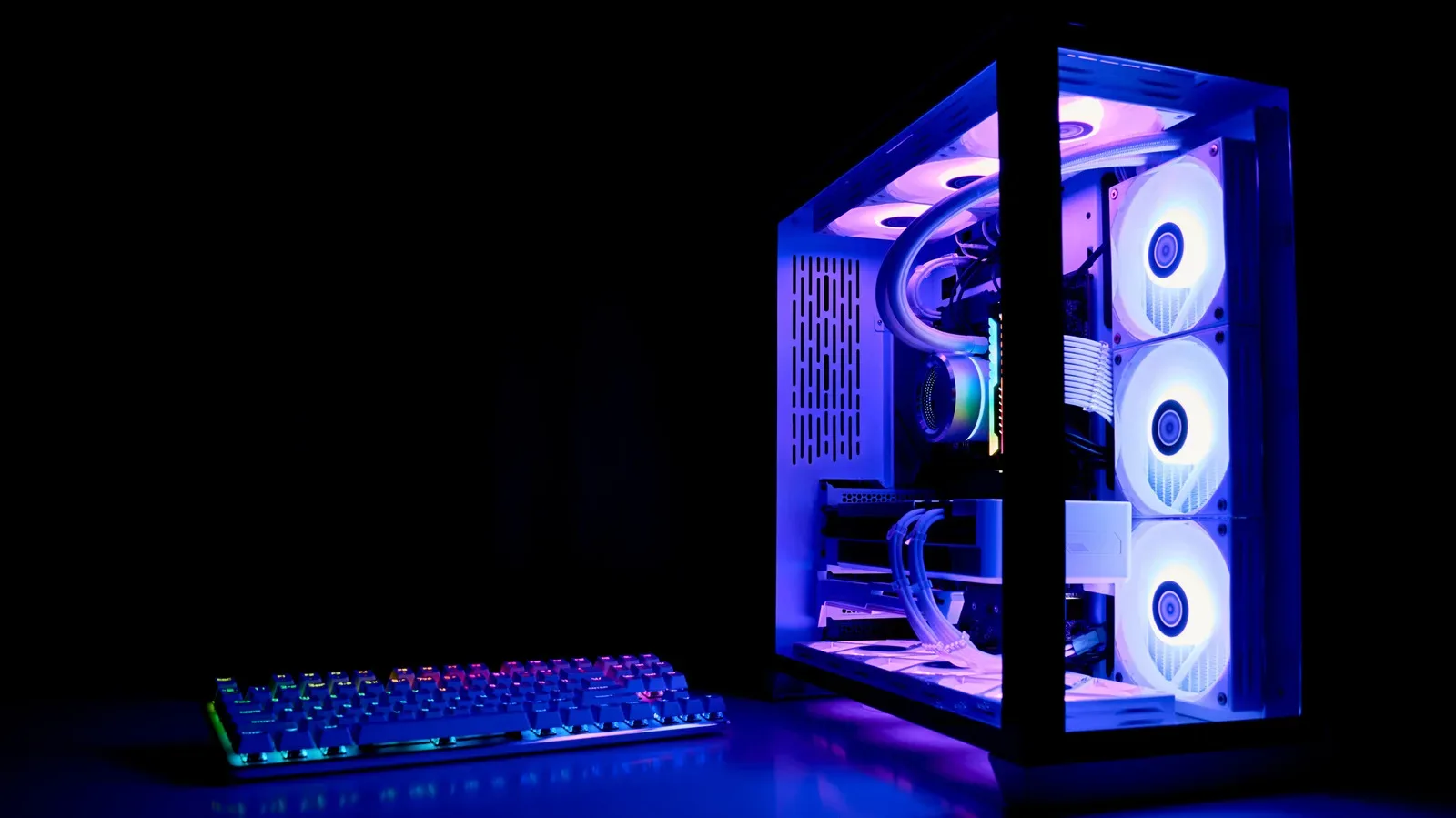Gaming PC tower elevated on a stand beneath a desk with clear airflow around its vents