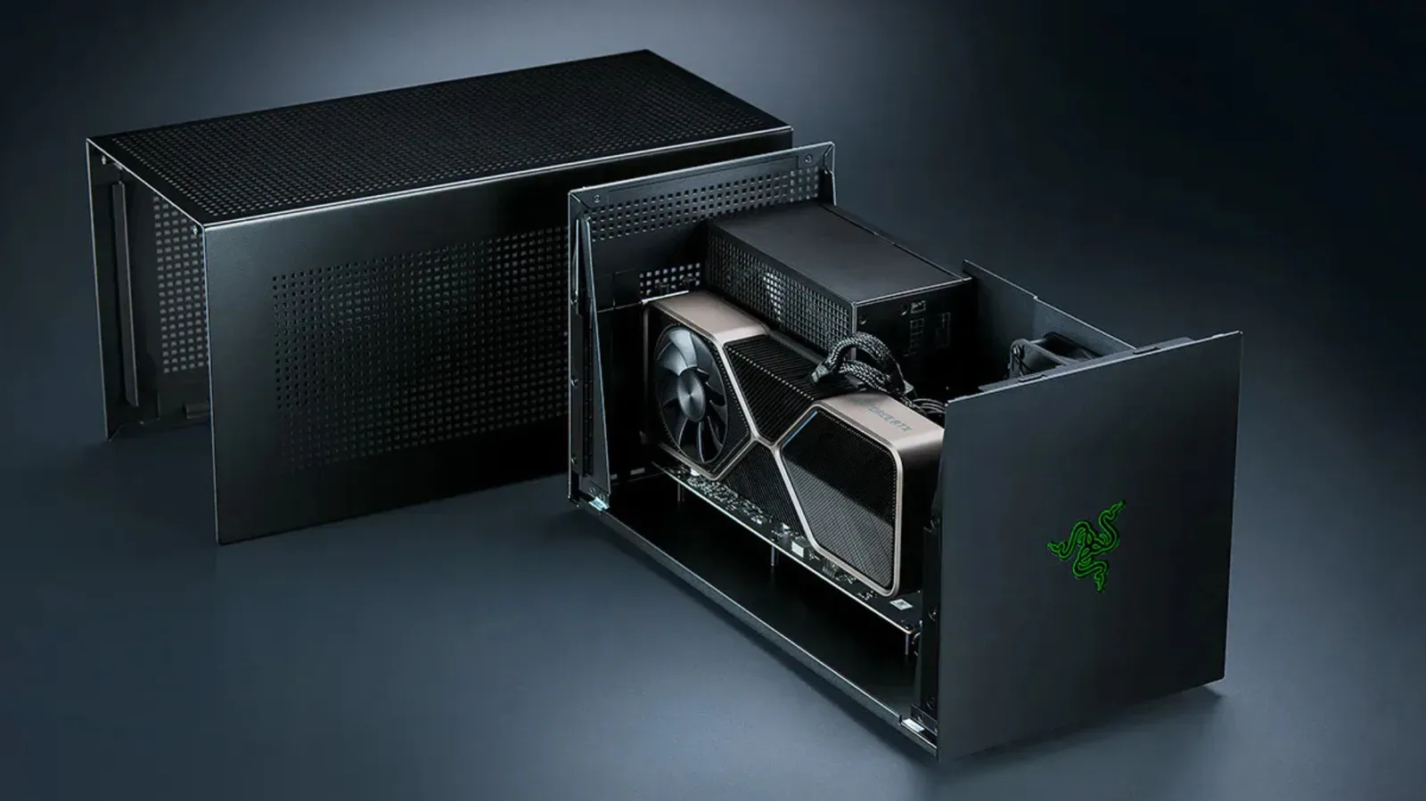 Desktop graphics card installed in an external GPU enclosure beside a laptop