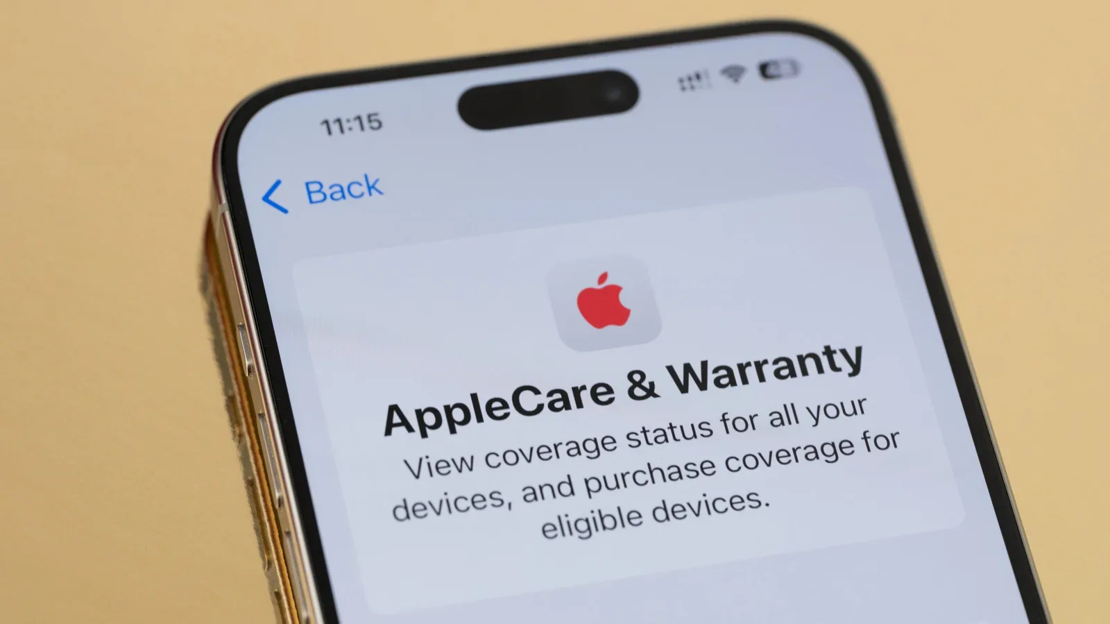 An iPhone with a cracked display beside a protective case