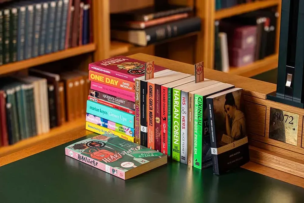 A selection of books adapted into films and television series on a public library shelf