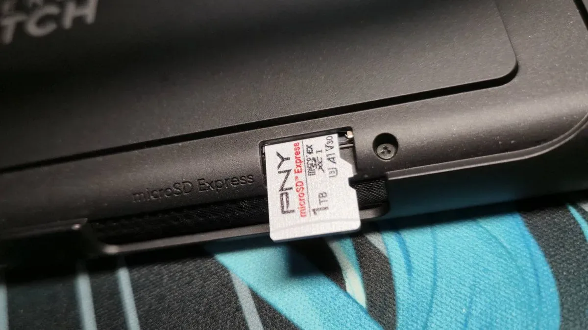 Image of the 1TB PNY microSD Express card sticking out of the Switch 2 card slot.