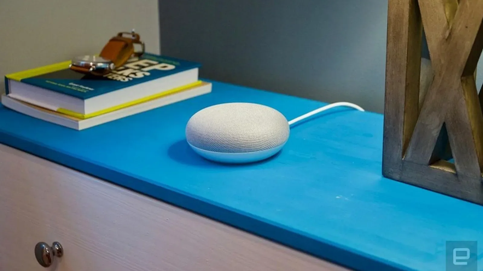 Google Home Mini turned over to show the reset button beneath the power cable