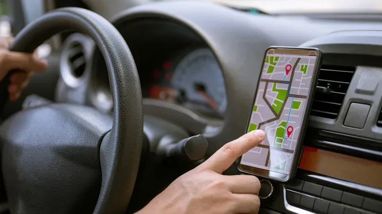 Portable CarPlay display mounted above an older factory car stereo