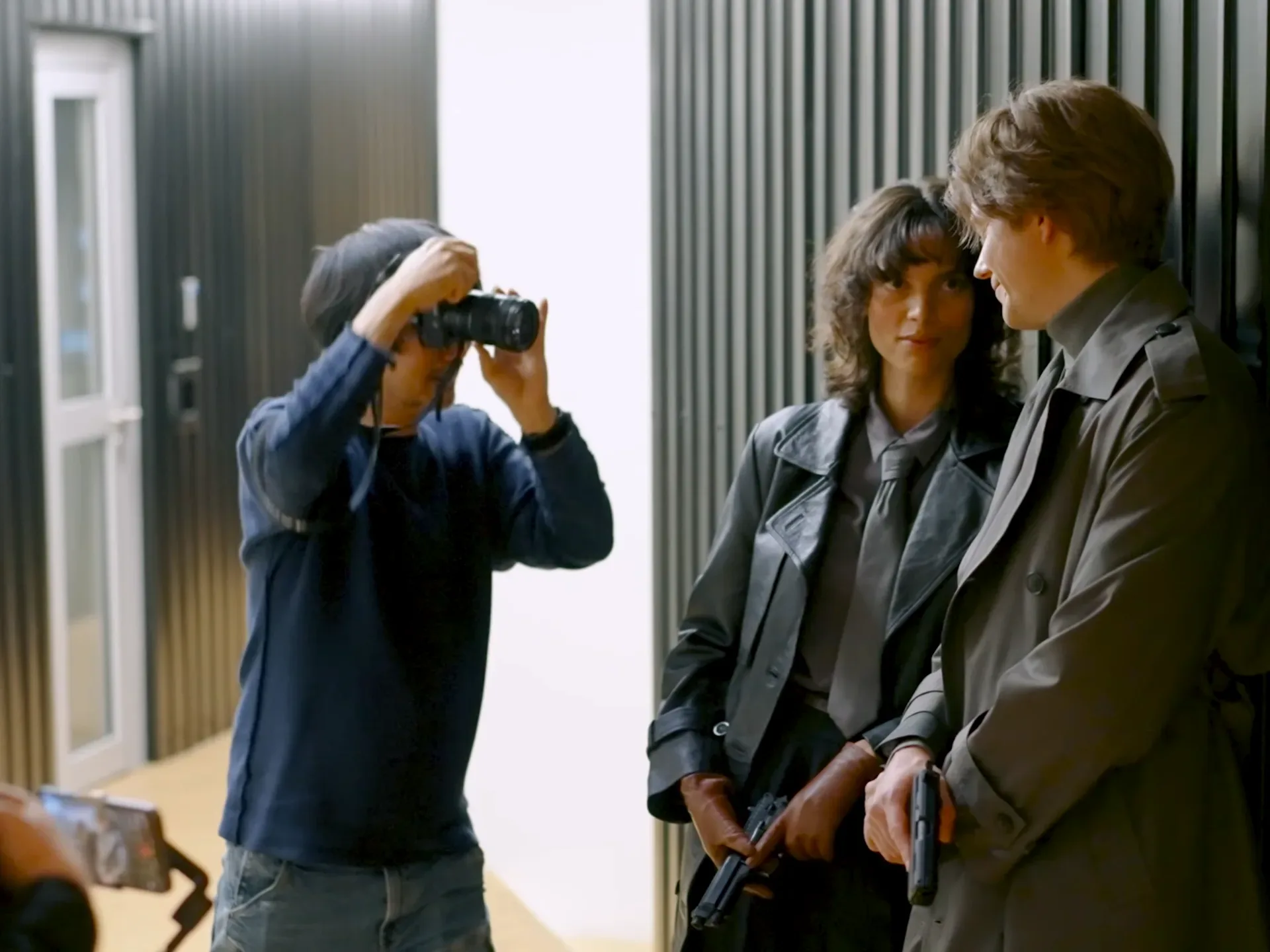Hideo Kojima taking a photo of charlee fraser and bill skarsgard for Physint cover art