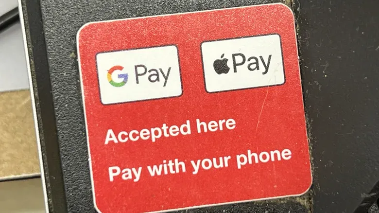 The Google Pay and Apple Pay logos on a sticker that says "Accepted Here".