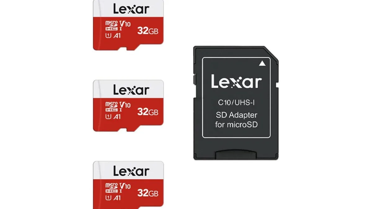 Three Lexar E-Series 32GB microSD cards arranged beside a compatible card reader