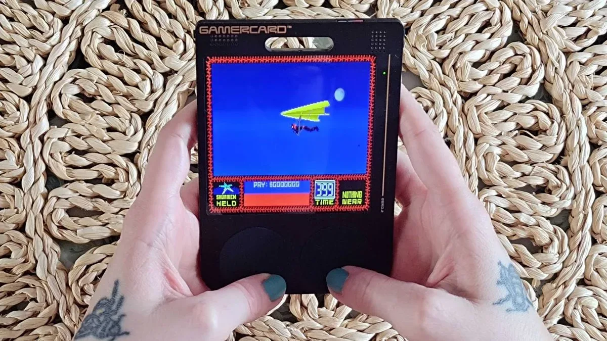 Hands using Gamercard to play Saboteur 2.