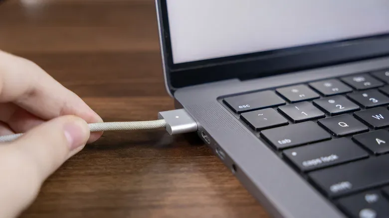 MacBook desk setup showing MagSafe charging and USB-C accessories