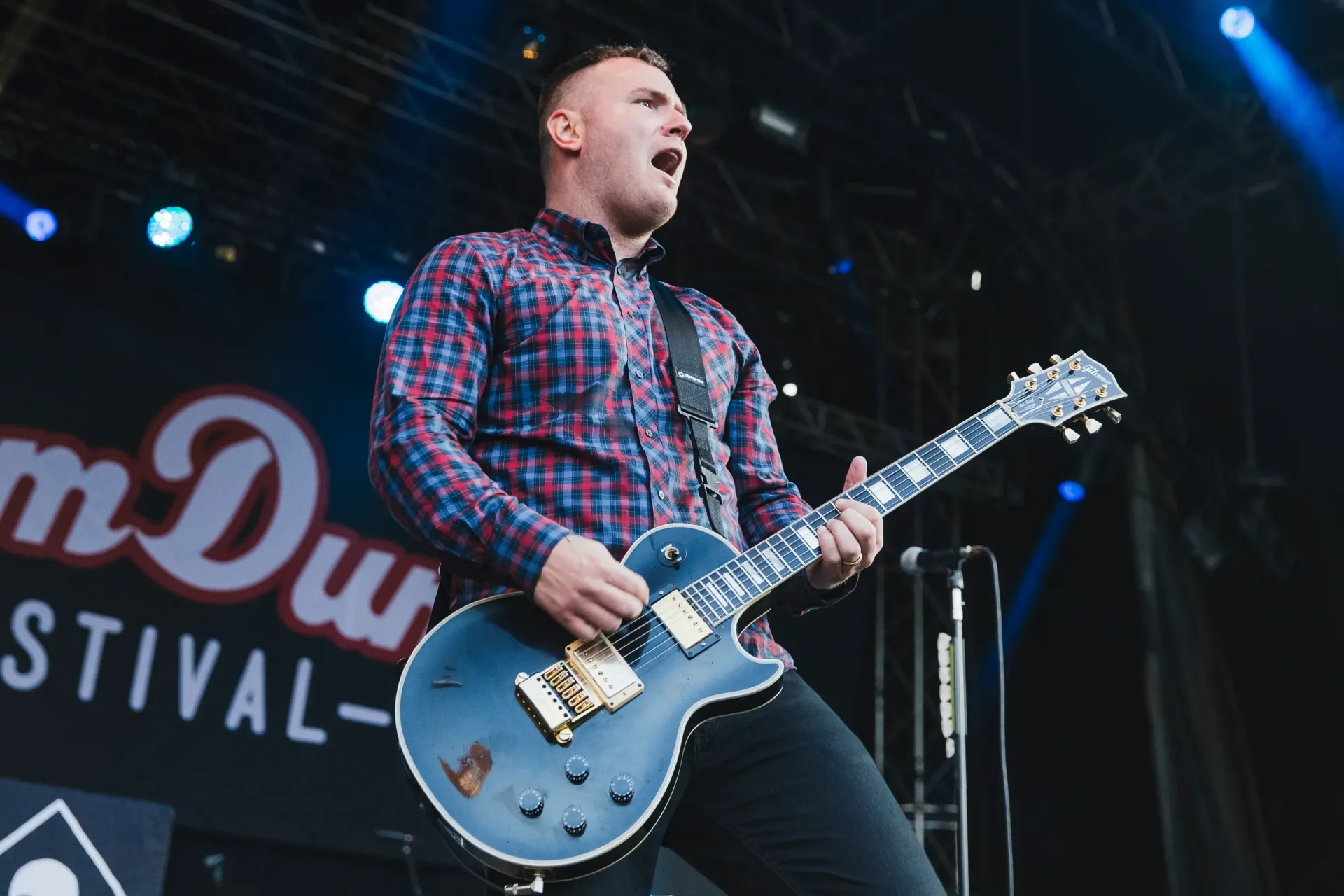 Chad Gilbert of New Found Glory performing with a guitar