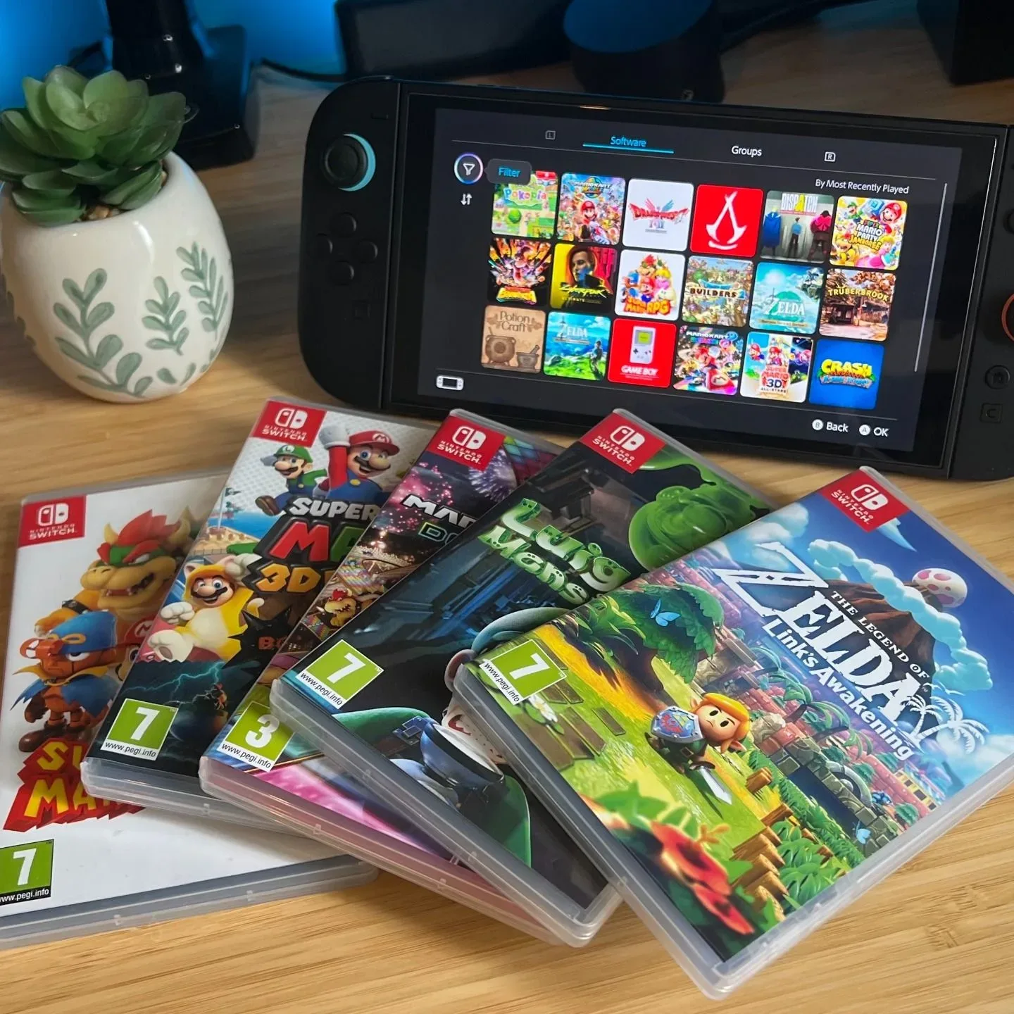 Nintendo Switch games with Switch 2 handheld on a wooden desk