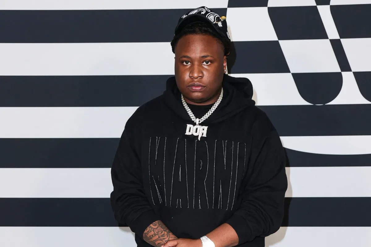 A respectful memorial-style image representing producer Tay Keith and music equipment